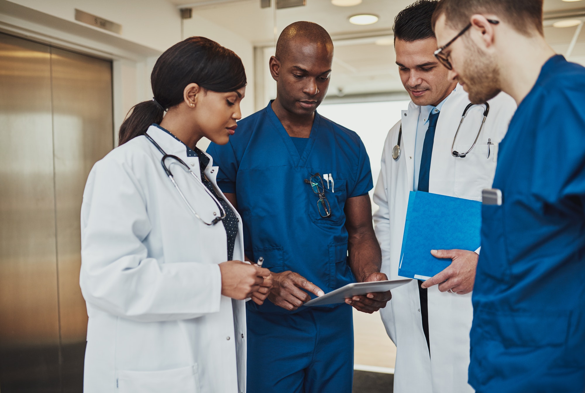 Multiracial team of doctors discussing a patient